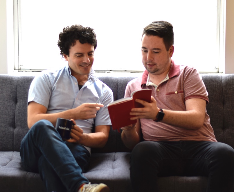 Me & a coworker in a marketing photo looking at an empty
notebook