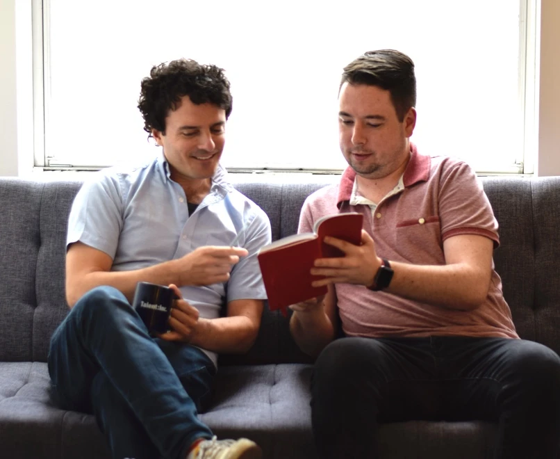 Me & a coworker in a marketing photo looking at an empty
notebook